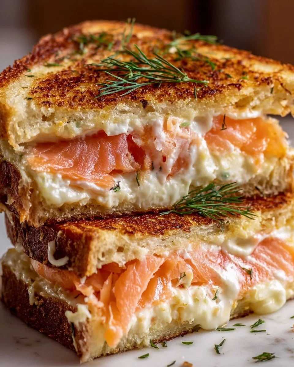 Delicious smoked salmon grilled cheese sandwich with melted cheese and herbs