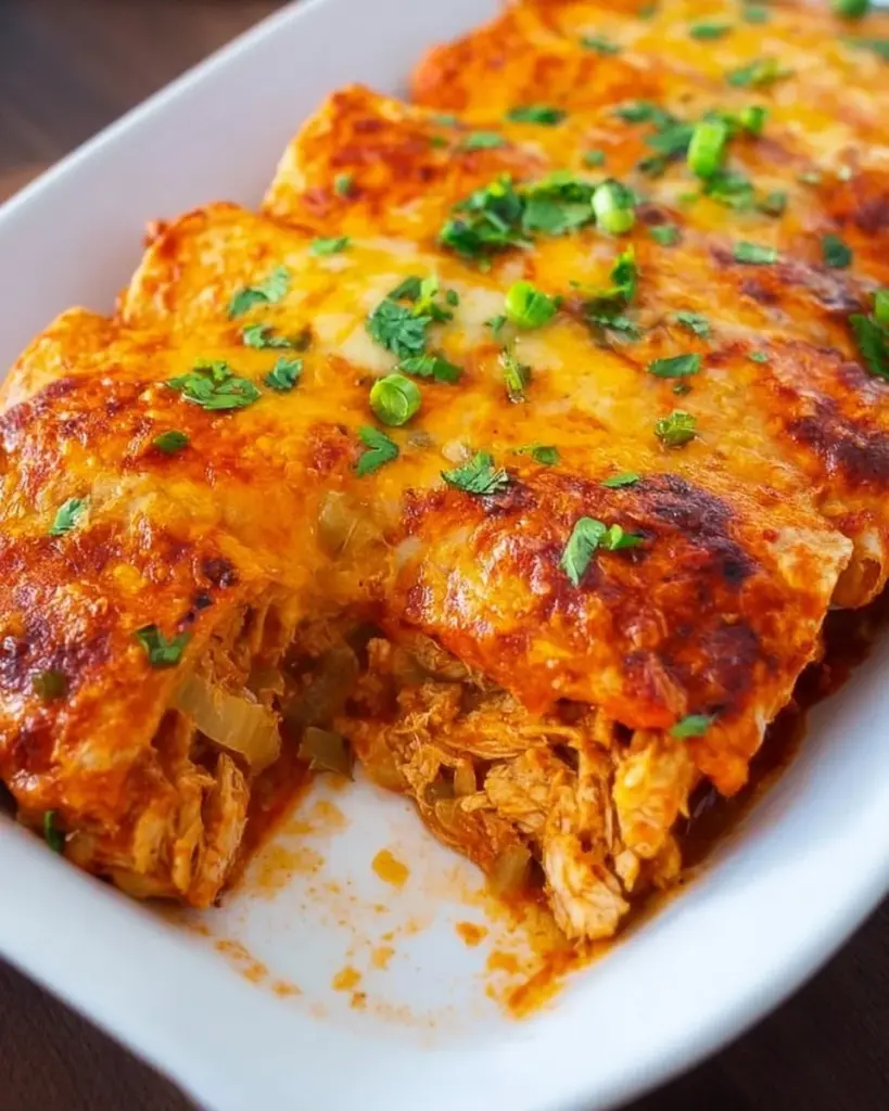 Delicious Chicken Enchiladas topped with cheese and garnished with cilantro